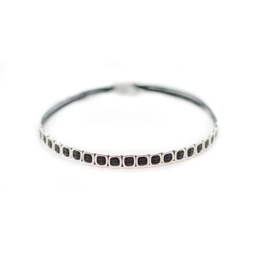 Custom design black string bracelet with  21 silver void beads.