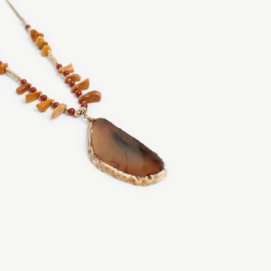 Brown natural stone necklace with small beads and a bigger pendant attached to a metal chain.