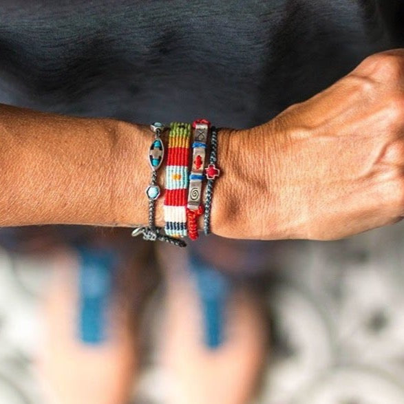 Faith bracelet on wrist combined with other bracelets