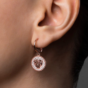 Photo of 925 sterling silver, rose gold plated earrings on a model.