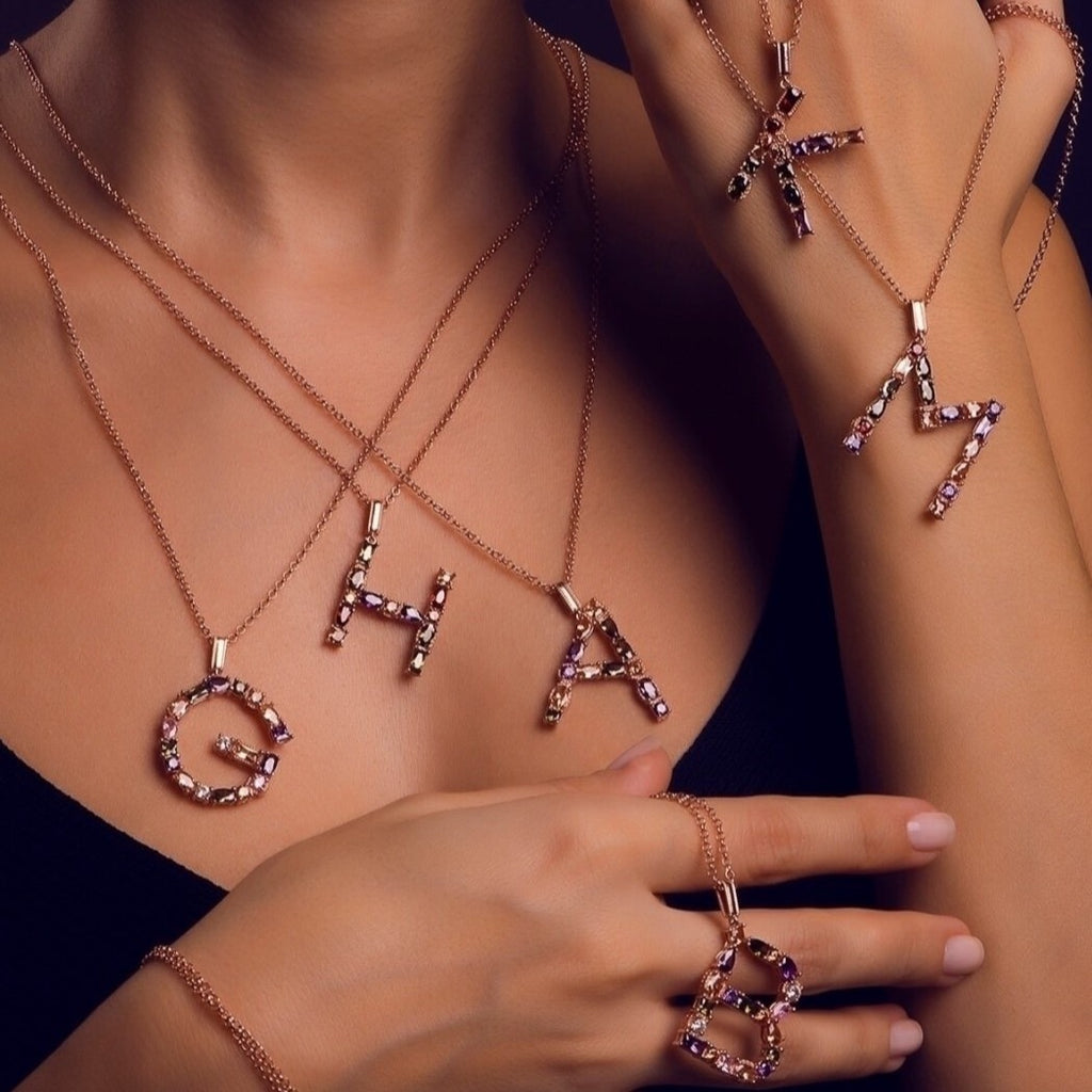 925 sterling silver, rose gold plated letter pendant necklaces on a model.