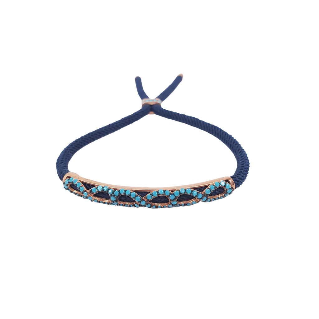 Turquoise zirconia, rose gold bracelet with infinity shape on a navy blue cord, front look.