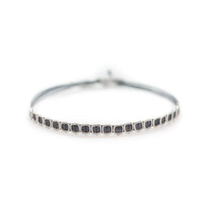 Custom design dark grey string bracelet with  21 silver square void beads.