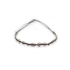 Silver bracelet with spa stone like beads, black string.