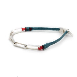 Custom design bracelet with silver chain attached to petrol blue stripe from side view.