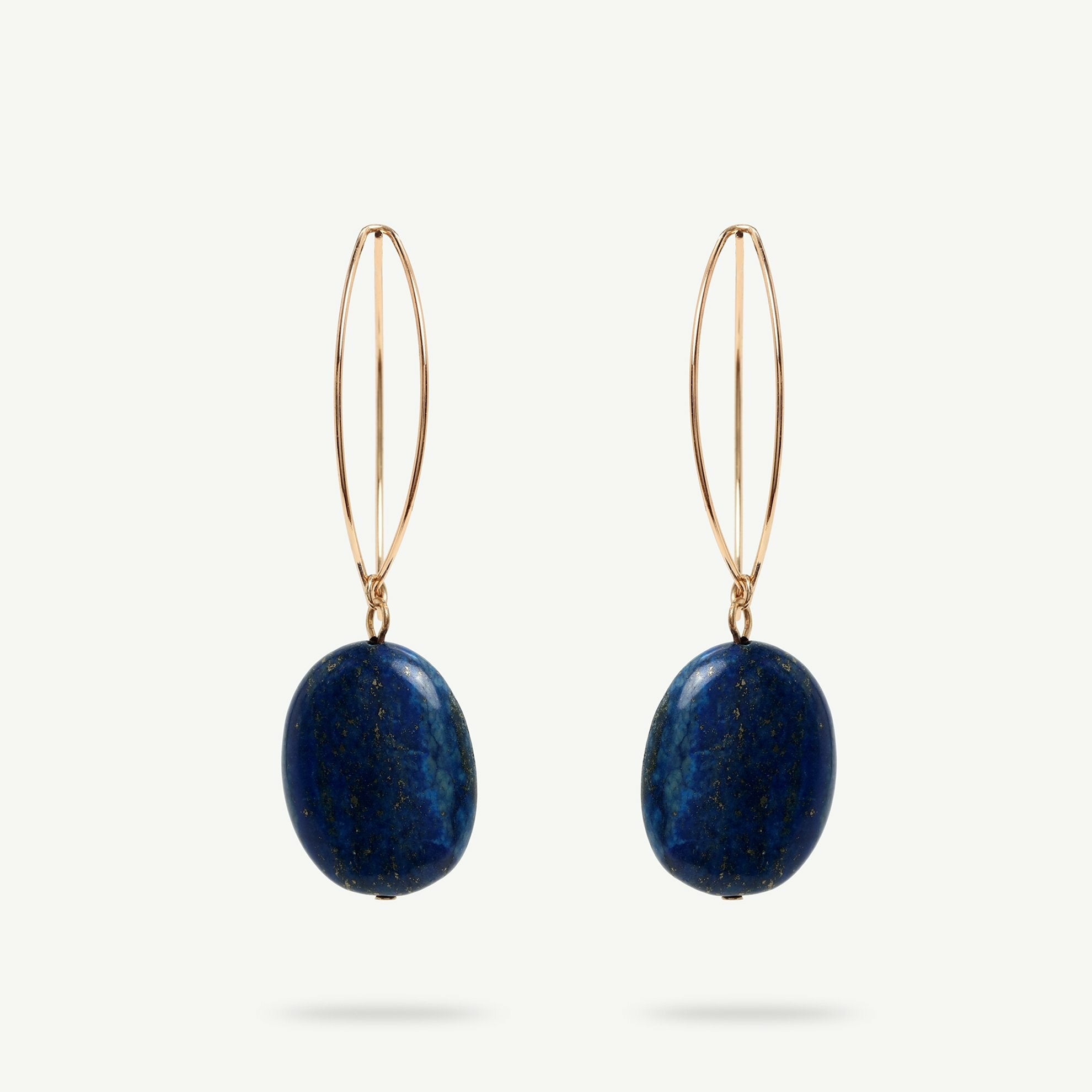Navy blue natural stone pendant earrings. The stone is attached to a brass metal part.